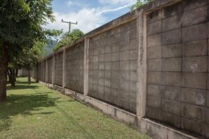 concrete-texture-wall-board-fence-panels-perspective-view-with-green-grass_3249-4148